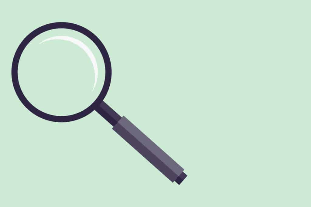 A magnifying glass on a green background