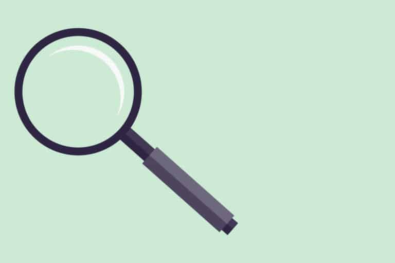 A magnifying glass on a green background