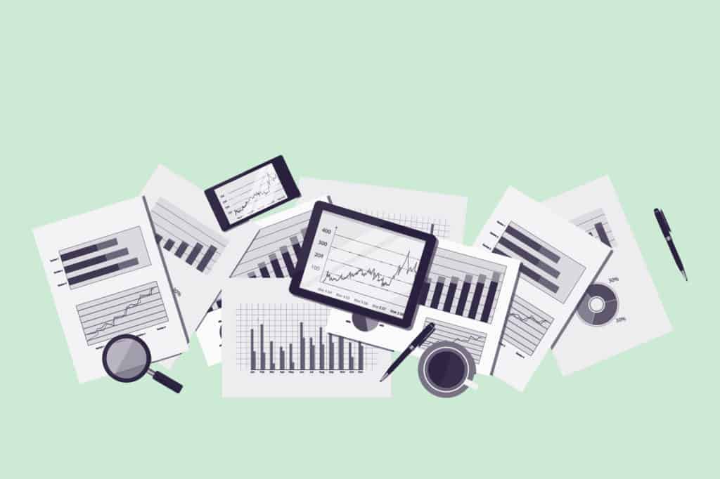 Green paperwork with graphs and charts on a desk