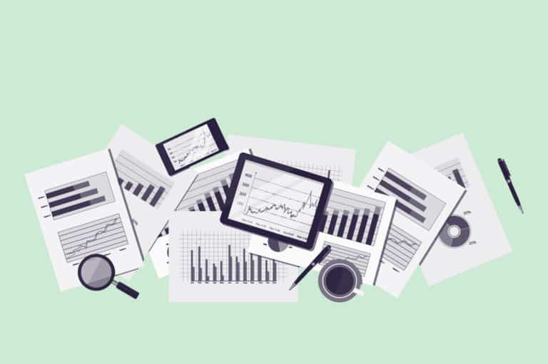Green paperwork with graphs and charts on a desk