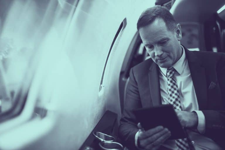 executive looking at climate metrics on a tablet