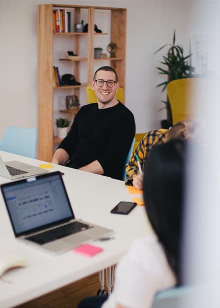 A man smiling at his colleague