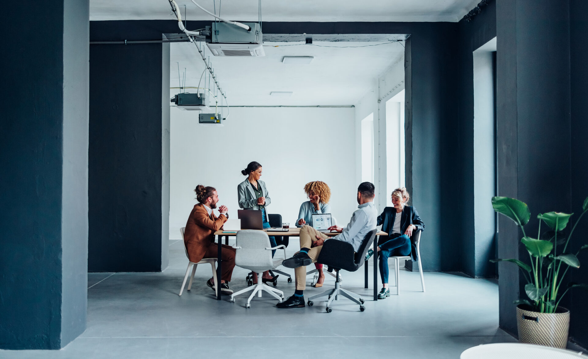 Business people talking around boardroom table