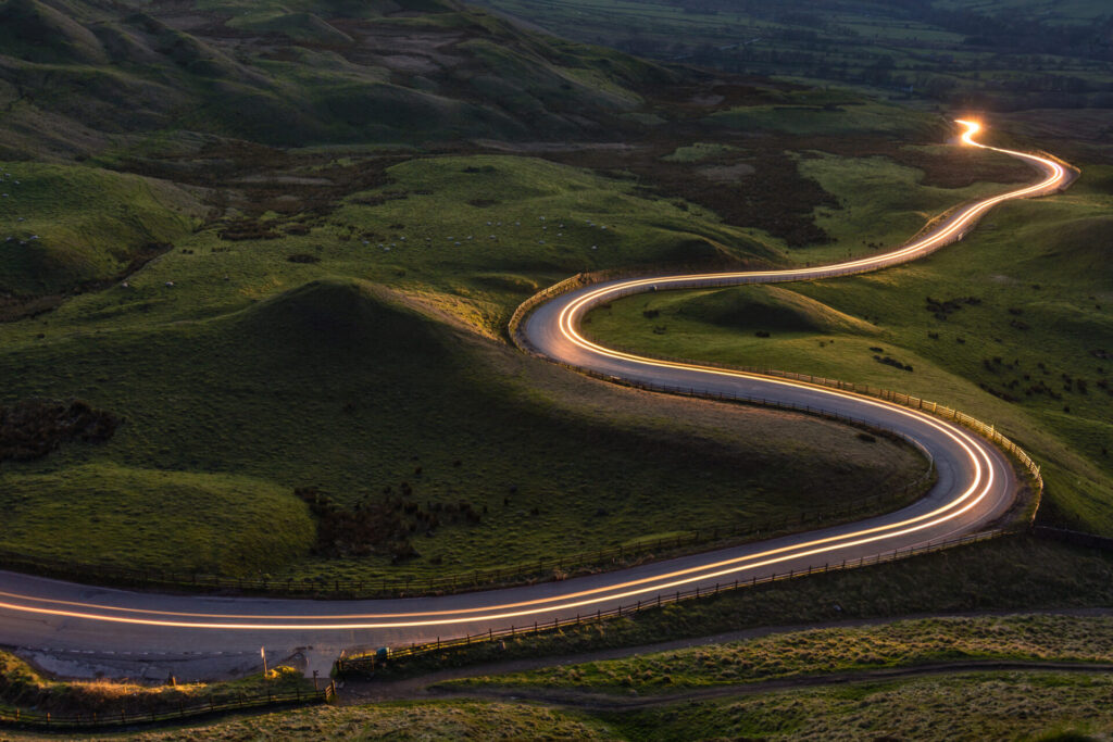 Highway runs through green hills